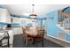 Eat-in kitchen featuring white cabinets and appliances, and light blue walls with a wooden dining set at 6001- P16A S Kings Highway, Myrtle Beach, SC 29575