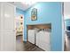Bright laundry room with blue walls and in-unit washer and dryer hookups at 6001- P16A S Kings Highway, Myrtle Beach, SC 29575