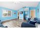 Bright living room with coastal decor and a glimpse into an adjacent bedroom and staircase at 6001- P16A S Kings Highway, Myrtle Beach, SC 29575