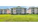 Three-story condo building with screened in back patios and grassy lawn at 627 Waterway Village Blvd. # 8E, Myrtle Beach, SC 29579