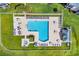 Aerial view of a large community pool featuring lounge chairs, tables, umbrellas, a hot tub, and lush landscaping at 627 Waterway Village Blvd. # 8E, Myrtle Beach, SC 29579
