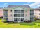 Three-story condo building with screened in back balconies and grassy lawn at 627 Waterway Village Blvd. # 8E, Myrtle Beach, SC 29579