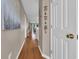 Bright hallway with wood floors leads to a living area with scenic views of trees and greenery at 627 Waterway Village Blvd. # 8E, Myrtle Beach, SC 29579