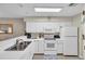 Cozy white kitchen with stainless steel sink, and white appliances offering ample storage at 627 Waterway Village Blvd. # 8E, Myrtle Beach, SC 29579