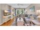 Bright living room featuring a comfortable sofa, stylish decor, and natural light from the adjacent balcony at 627 Waterway Village Blvd. # 8E, Myrtle Beach, SC 29579