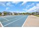View of the community tennis court, perfect for sports enthusiasts, with blue and gray court, netting, and fencing at 627 Waterway Village Blvd. # 8E, Myrtle Beach, SC 29579