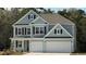 Charming two-story home with light blue siding, black shutters, and a two-car garage at 7179 Shooting Star Way, Myrtle Beach, SC 29579