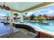 Poolside bar with granite countertops, brick accents, and a view of the pool and surrounding landscape at 7179 Shooting Star Way, Myrtle Beach, SC 29579