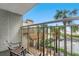 Balcony view of a condo complex overlooking a tiki bar, pool, palm trees, and the beach, with outdoor seating at 7200 N Ocean Blvd. # 257, Myrtle Beach, SC 29572