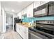 Well-equipped condo kitchen with stainless steel appliances, white cabinetry, tile backsplash, and easy access to living areas at 7200 N Ocean Blvd. # 257, Myrtle Beach, SC 29572