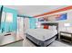 Stylish condo bedroom featuring a comfortable bed, modern furnishings, beach-themed decor, and a sliding barn door at 7200 N Ocean Blvd. # 257, Myrtle Beach, SC 29572