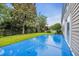 Backyard featuring a patio, manicured lawn, mature trees, and perimeter fence at 760 Carolina Farms Blvd., Myrtle Beach, SC 29579