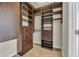 Large walk-in closet with dark-wood shelving and built-in drawers at 760 Carolina Farms Blvd., Myrtle Beach, SC 29579