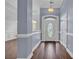 Elegant foyer with rich hardwood floors, wainscoting, and a decorative glass front door, creating a grand entrance at 760 Carolina Farms Blvd., Myrtle Beach, SC 29579
