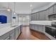 Bright kitchen with modern cabinetry, hardwood floors, and stainless steel appliances at 760 Carolina Farms Blvd., Myrtle Beach, SC 29579