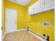 Bright laundry room with storage cabinets, tile floor, and washer/dryer hookups at 760 Carolina Farms Blvd., Myrtle Beach, SC 29579