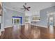 Spacious living room featuring hardwood floors, a ceiling fan, and seamless flow to the kitchen and outdoor patio at 760 Carolina Farms Blvd., Myrtle Beach, SC 29579