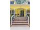 Inviting front porch with brick steps, black railings, and cozy seating, leading to front door at 786 Wild Oak Ln. Nw, Calabash, NC 28467