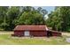 Large red barn with a metal roof, set in a vast grassy area at 951 Herriott Farms Dr., Georgetown, SC 29440