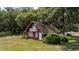 Quaint two-story cottage with a balcony, nestled in a wooded, grassy landscape at 951 Herriott Farms Dr., Georgetown, SC 29440