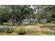 Scenic view of a home with a sunroom and detached garage near the waterfront at 951 Herriott Farms Dr., Georgetown, SC 29440