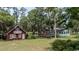 Picturesque estate featuring multiple buildings, including a red cottage and waterfront access at 951 Herriott Farms Dr., Georgetown, SC 29440