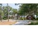 Spacious property featuring a charming house, detached garage, and lush green surroundings at 951 Herriott Farms Dr., Georgetown, SC 29440