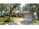 Charming brick home with a two-car garage, mature trees, and well-manicured landscaping at 951 Herriott Farms Dr., Georgetown, SC 29440