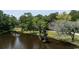 View of a serene pond surrounded by lush trees and greenery on the property at 951 Herriott Farms Dr., Georgetown, SC 29440
