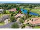 An aerial view of a beautiful home nestled among mature trees near a pond and golf course at 9737 Catalonia Ct., Myrtle Beach, SC 29579
