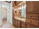 Bathroom vanity with granite countertop, dark wood cabinets, and decorative lighting at 9737 Catalonia Ct., Myrtle Beach, SC 29579