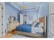 Relaxing bedroom with light blue walls, a decorative dresser and a large window with shutters at 9737 Catalonia Ct., Myrtle Beach, SC 29579