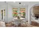 Bright dining area with a round table, white chairs, and views of the backyard pool at 9737 Catalonia Ct., Myrtle Beach, SC 29579