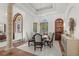 A dining room with a decorative chandelier, travertine floors, and arched doorway at 9737 Catalonia Ct., Myrtle Beach, SC 29579