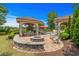 An outdoor fire pit featuring石 masonry and paver flooring, with a covered outdoor seating area at 9737 Catalonia Ct., Myrtle Beach, SC 29579