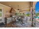 An outdoor kitchen featuring a grill, countertop seating, and a covered dining area at 9737 Catalonia Ct., Myrtle Beach, SC 29579