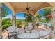 A covered outdoor seating area with comfortable seating and lush landscaping near the pool at 9737 Catalonia Ct., Myrtle Beach, SC 29579