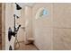 Walk-in shower featuring dual shower heads, bench seat, and tiled surround at 9737 Catalonia Ct., Myrtle Beach, SC 29579