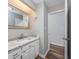 Bright bathroom featuring a white vanity with a marble countertop and a framed mirror at 100 St. Andrews Ln., Myrtle Beach, SC 29588