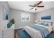 Stylishly staged bedroom with a comfortable bed, blue accents, and ample natural light at 100 St. Andrews Ln., Myrtle Beach, SC 29588