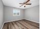 Clean bedroom featuring wood floors, a ceiling fan, and a window for natural light at 100 St. Andrews Ln., Myrtle Beach, SC 29588