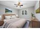 Comfortable bedroom featuring a cozy bed, wood headboard, ceiling fan, and soothing wall art at 100 St. Andrews Ln., Myrtle Beach, SC 29588