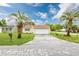 Charming home with a well-maintained lawn, a long driveway, and palm trees in the front yard at 100 St. Andrews Ln., Myrtle Beach, SC 29588