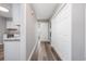 Inviting hallway with wood floors leading to the front door and a glimpse of the kitchen area at 100 St. Andrews Ln., Myrtle Beach, SC 29588