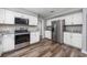 Bright kitchen featuring white cabinets, stainless steel appliances, and wood-look floors at 100 St. Andrews Ln., Myrtle Beach, SC 29588