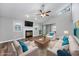 Bright living room features a fireplace, ceiling fan, hardwood floors, and a sliding glass door at 100 St. Andrews Ln., Myrtle Beach, SC 29588