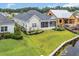 Aerial view of a home with a backyard, screened porch, pond, and dock, nestled in a green landscape at 1024 Pochard Dr., Conway, SC 29526
