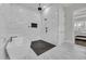 This bright bathroom features a walk-in shower with multiple shower heads, a soaking tub, and tiled accent wall at 1024 Pochard Dr., Conway, SC 29526