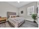 Comfortable bedroom with soft lighting, a queen-sized bed with decorative pillows, and a soothing gray color scheme at 1024 Pochard Dr., Conway, SC 29526