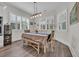 Bright dining room featuring shuttered windows and a dining table with bench seating and stylish light fixture at 1024 Pochard Dr., Conway, SC 29526